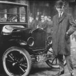 henry ford, founder of ford motor company, standing next to a ford car. ulmer